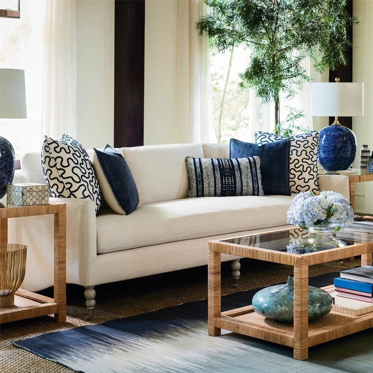 Ashley End Table styled beside a white sofa with blue accents in a living room. Styled view.