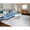 Avery Hand-Knotted Rug styled in a living room with blue sofa. Styled view. 