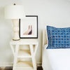 Berkeley Table Lamp styled on a white side table with artwork. Styled view.