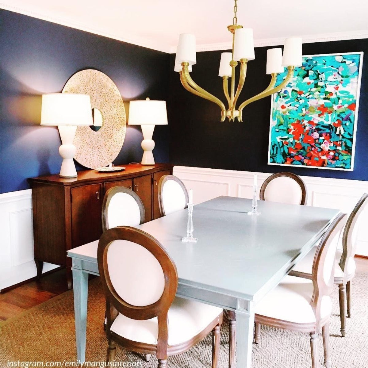 Berkeley Table Lamp styled on a wood chest in a dining room. Styled view.