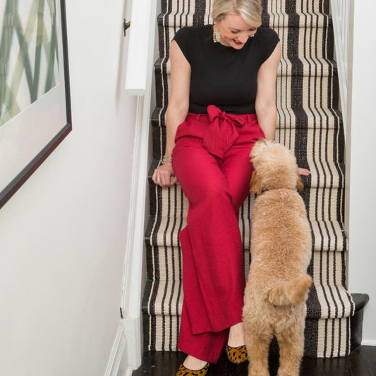 Birmingham Black Woven Cotton Rug styled on stairs. Styled view. 