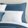 Boyfriend Aegean matelasse sham styled with white sheets. Styled view. 