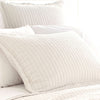 Boyfriend Ivory matelasse sham styled with white sheets. Styled view. 