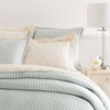 Boyfriend Sky matelasse coverlet styled with polka-dot sheets. Styled view. 