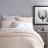 Boyfriend Slipper Pink Matelasse Coverlet styled with floral sheets. Styled view. 