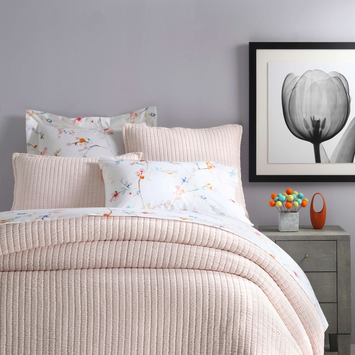 Boyfriend Slipper Pink Matelasse Coverlet styled with floral sheets. Styled view. 