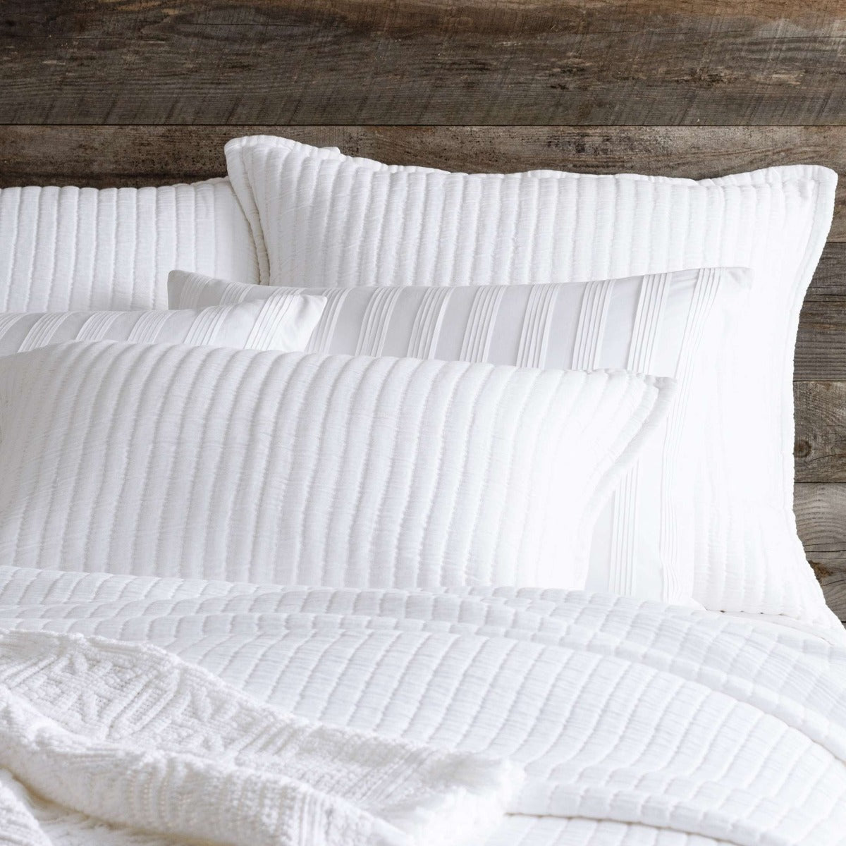 Boyfriend White Matelasse Sham styled with white sheets. Styled view. 