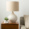 Brookmount Table Lamp styled on a wood side table beside a sofa. Styled view.