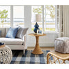 Claire Ceramic Table Lamp styled on a wicker table with sofa and chairs. Styled view.