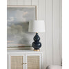 Claire Ceramic Table styled on a white console with artwork. Styled view.