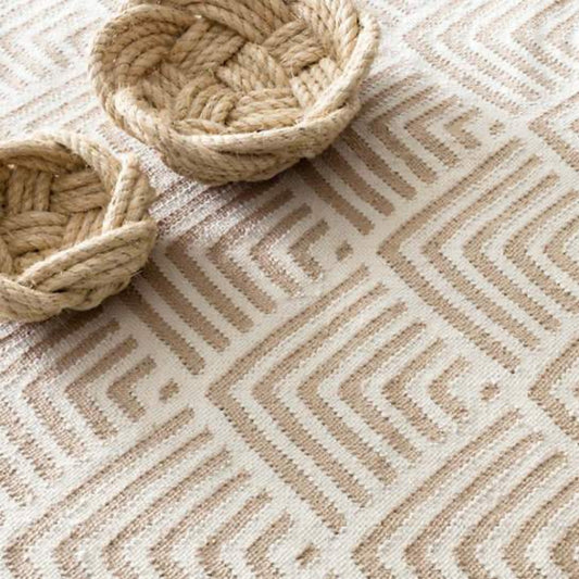 Cleo Cement Indoor/Outdoor Rug styled under woven baskets. Styled view. 