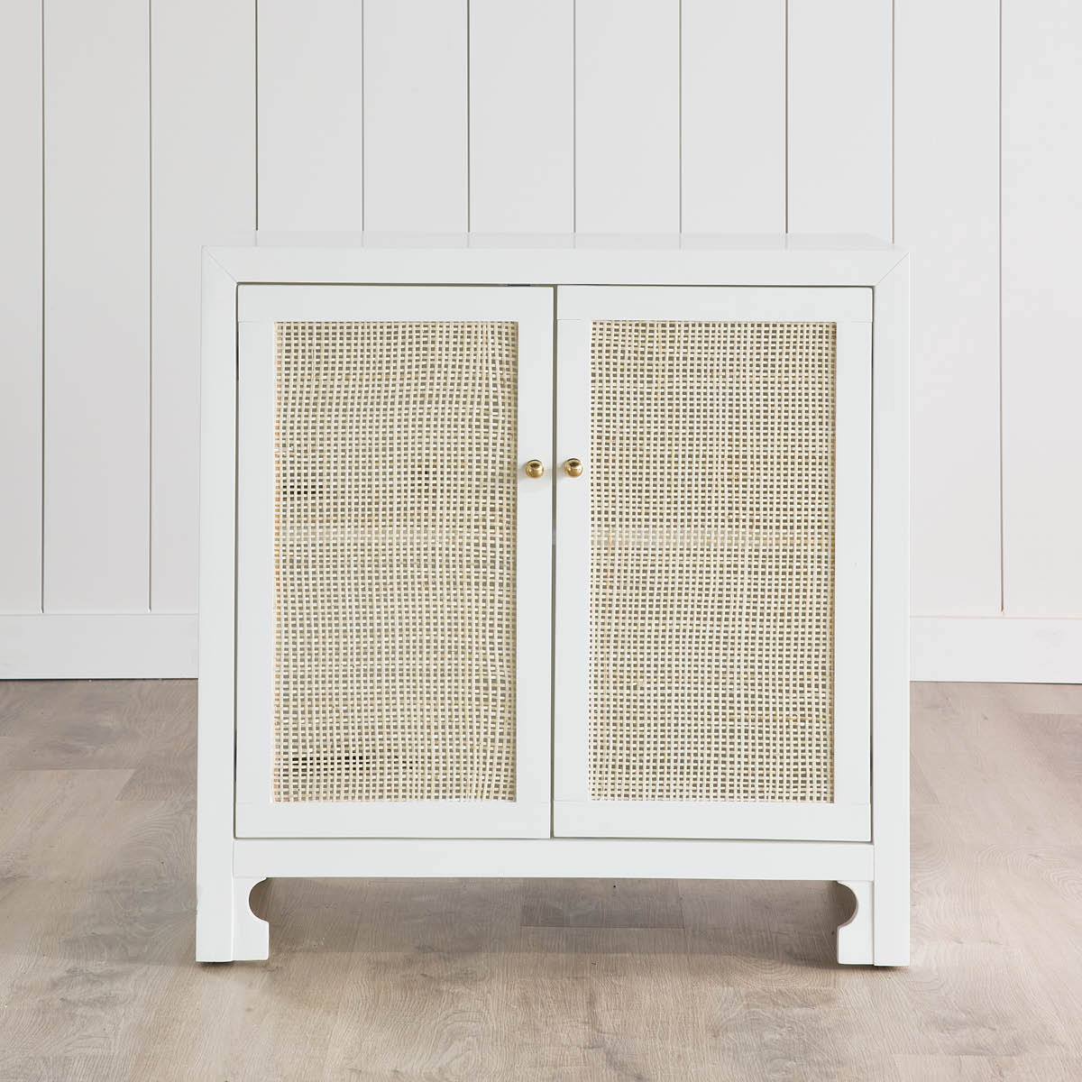 Colette Occasional Cabinet on wood floors in a white room. Styled view.