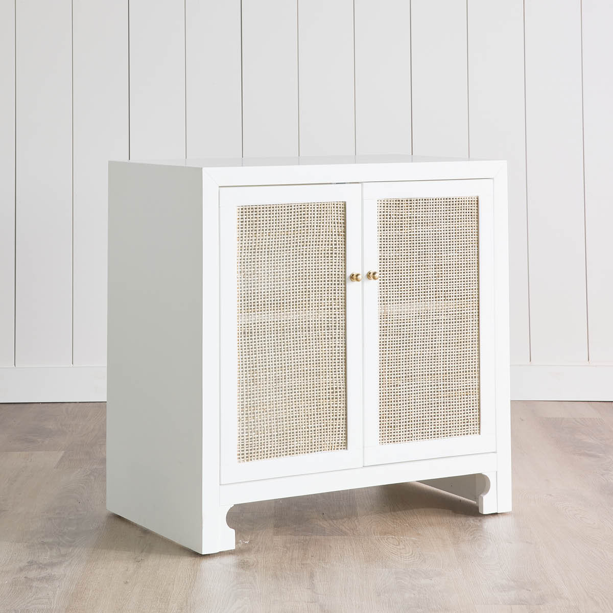 Colette Occasional Cabinet on wood floors in a white room. Right angle view.