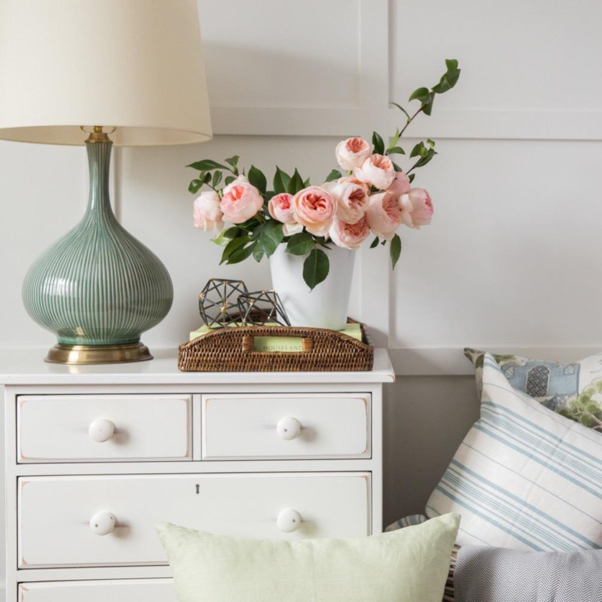 Dark Brown Rattan Tray styled with florals on a white side table. Styled view.