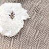 Diamond Fieldstone/Ivory Indoor/Outdoor Rug styled under a white stone. Styled view. 