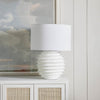 Eaton Metal Table Lamp styled on a white side table with artwork. Styled view.