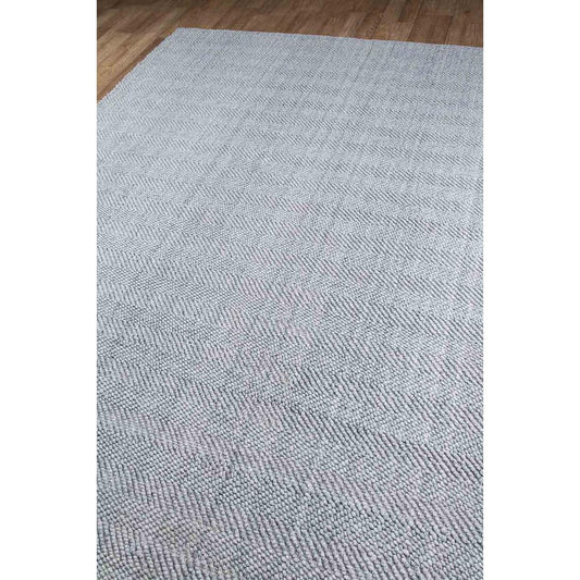 Edenbridge Rug - Grey over wood floor. Styled view. 