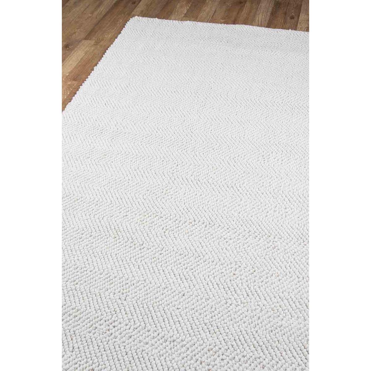 Edenbridge Rug - Ivory over wood floor. Styled view. 