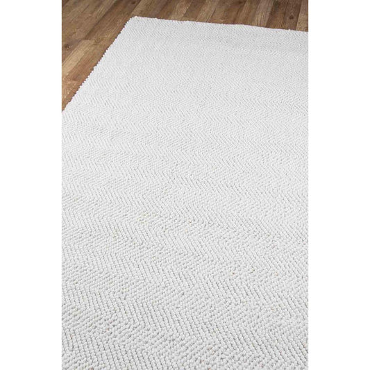 Edenbridge Rug - Ivory over wood floor. Styled view. 