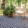 Elizabeth Navy Indoor/Outdoor Rug styled under outdoor furniture and planters. Styled view. 