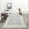 Ellesworth Rug styled with a mirror, bench and greenery. Styled view. 