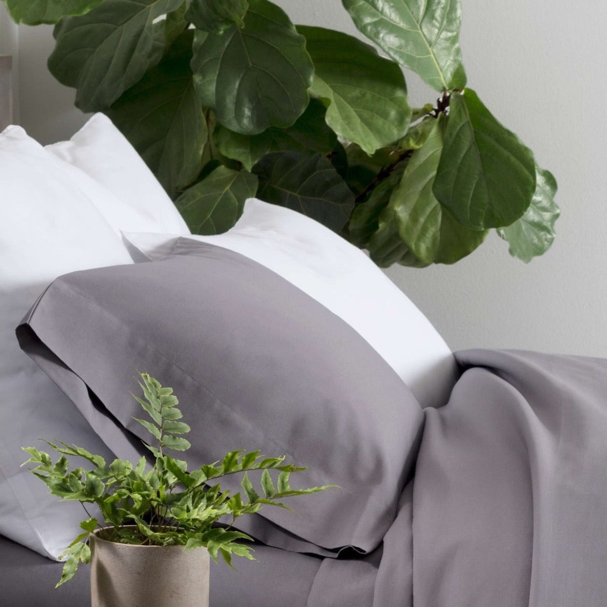 Essential Percale White Sham styled with grey sheets. Styled view. 