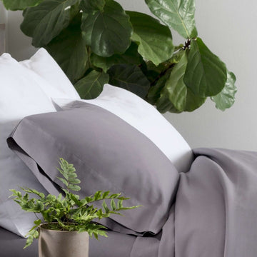 Essential Percale White Sham styled with grey sheets. Styled view. 