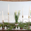Hand-Dipped Danish Tapers - Cream styled with gold candlesticks on a winter dining table. Styled view.