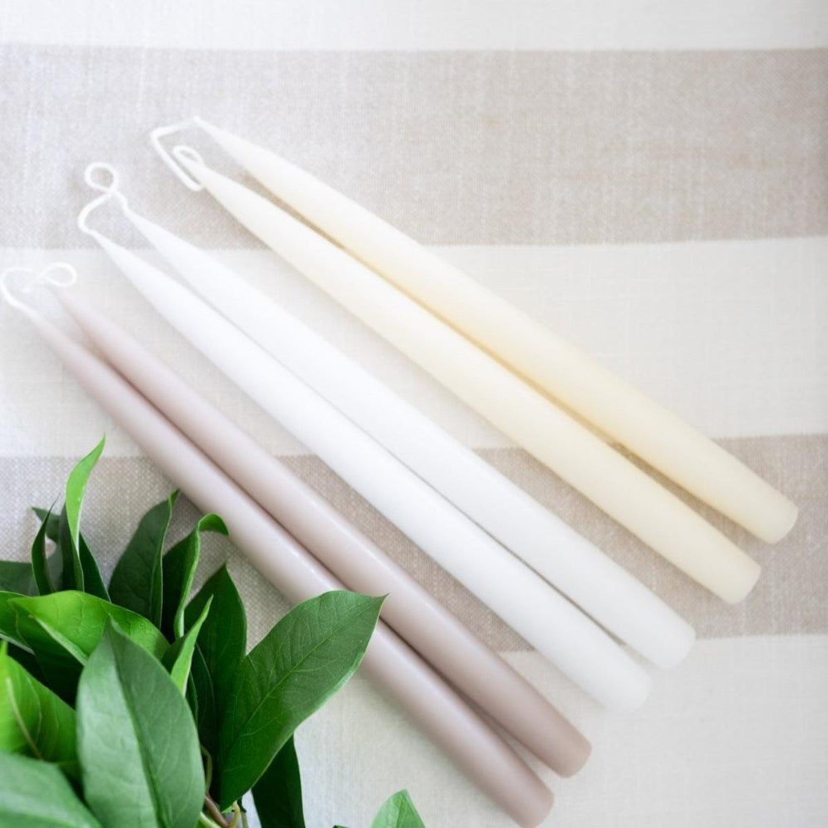 Hand-Dipped Danish Tapers - Linen styled on white surface. Styled view.