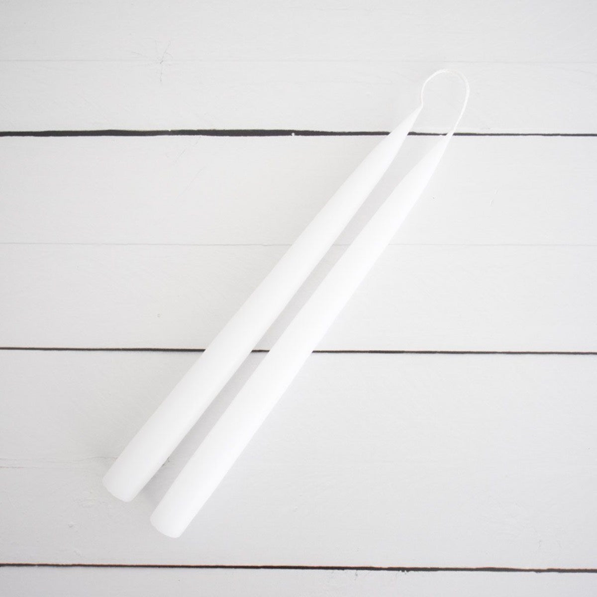 Hand-Dipped Danish Tapers - White styled on a white back. Styled view. 