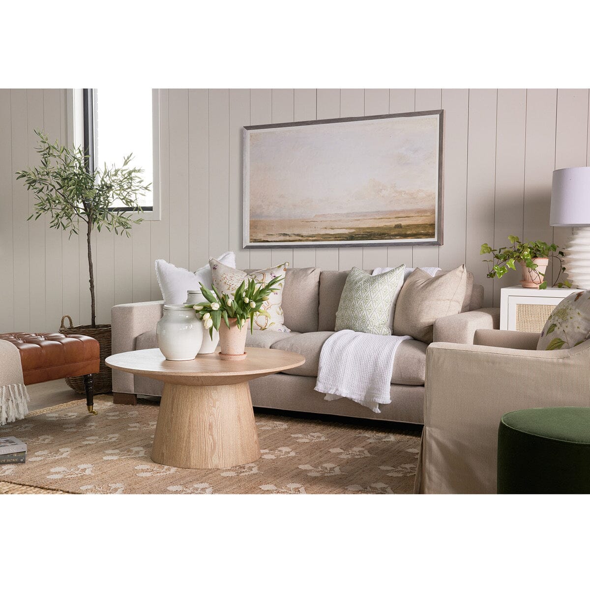 Henry Sofa styled with artwork, greenery and spring decor. Styled view. 