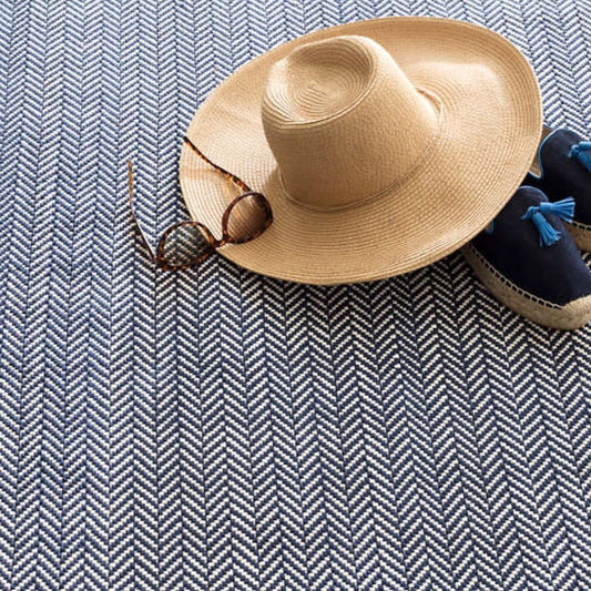 Herringbone Navy/Ivory Indoor/Outdoor Rug styled under clothing. Styled view. 