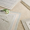 Herringbone Pearl Grey/White Indoor/Outdoor Rug styled with neutral rugs. Styled view. 