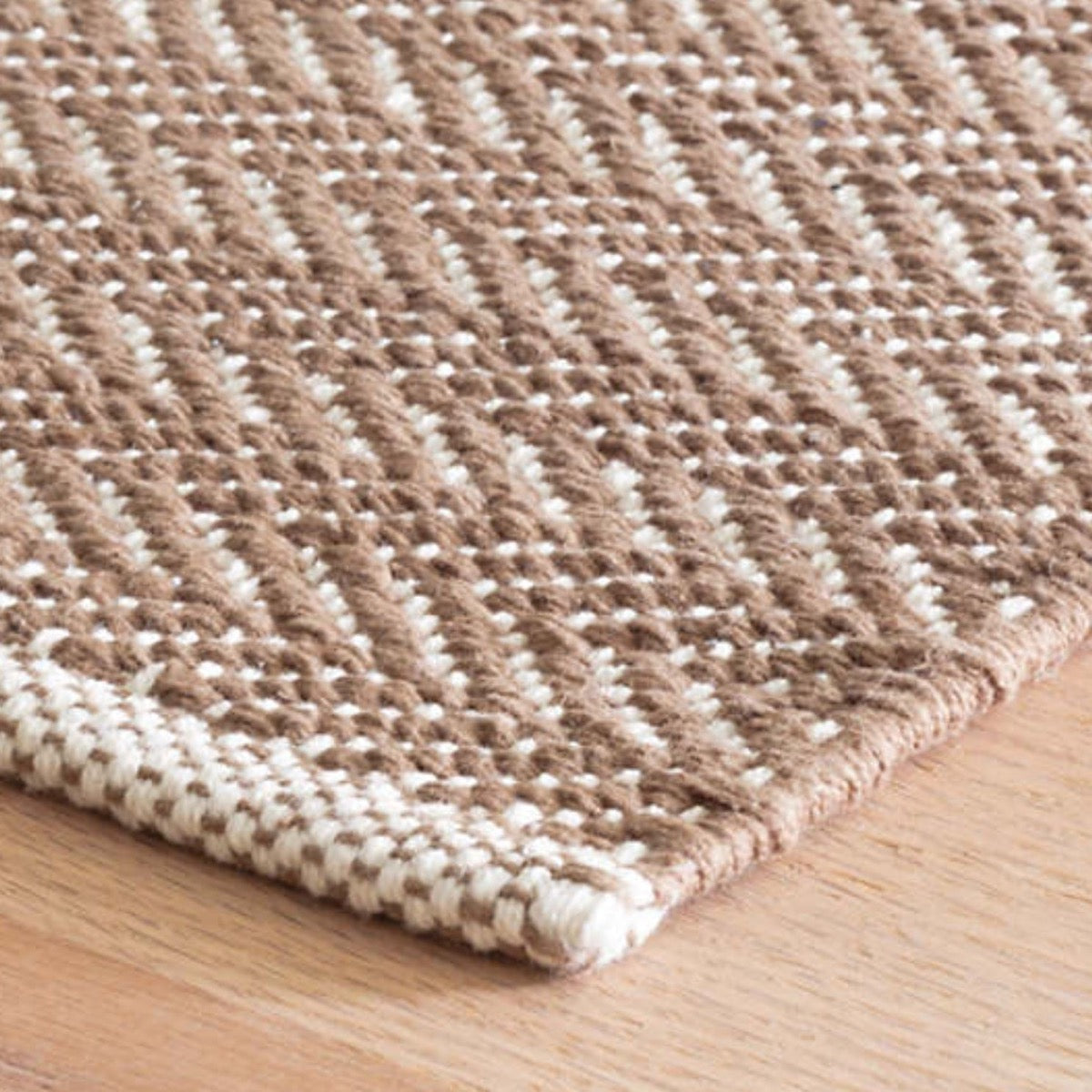 Herringbone Stone Woven Cotton Rug corner detail. Close-up detail view. 