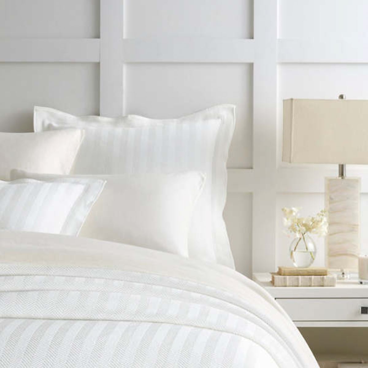 Herringbone White Matelasse Coverlet styled with white sheets. Styled view. 