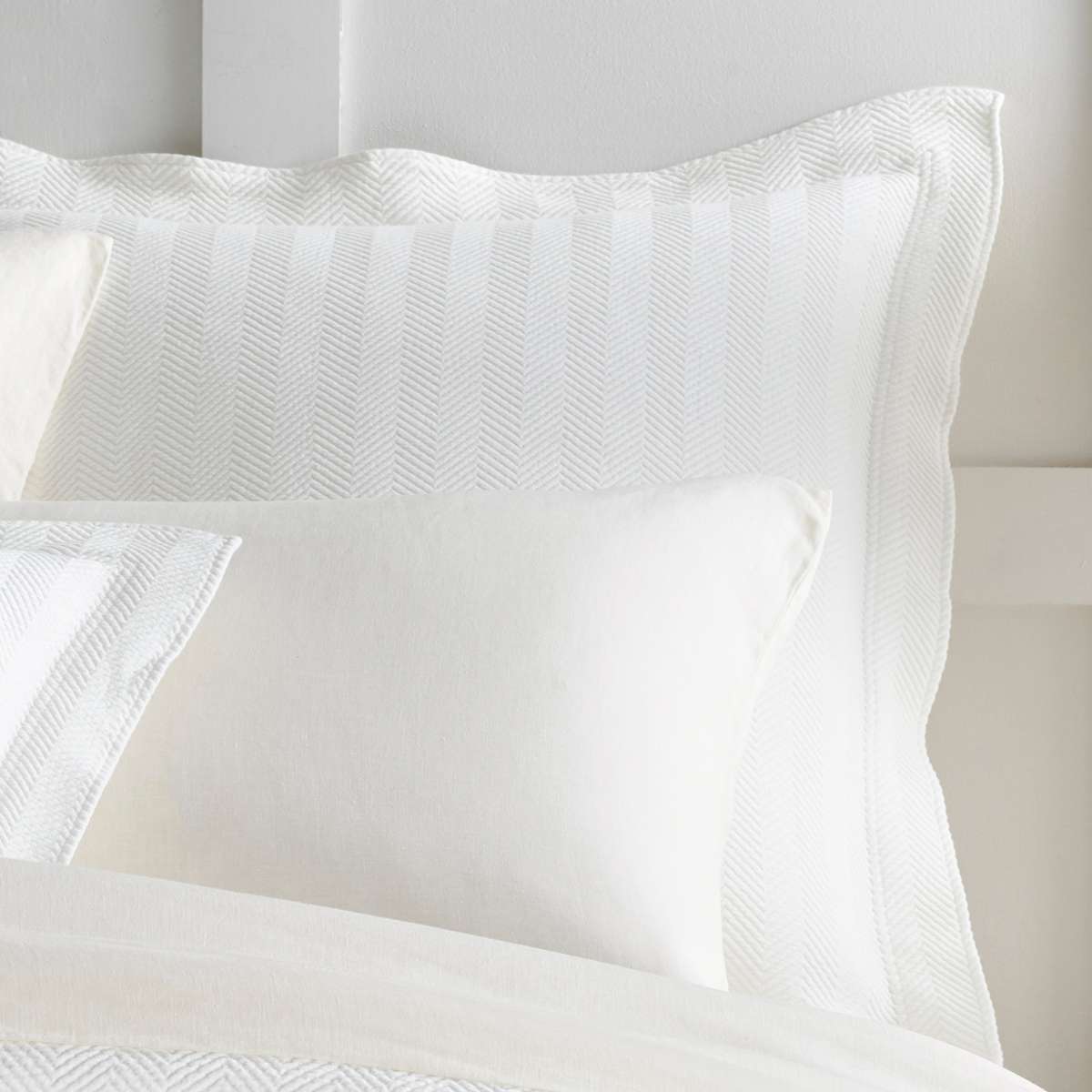 Herringbone White Matelasse Sham styled with white bedding. Styled view. 