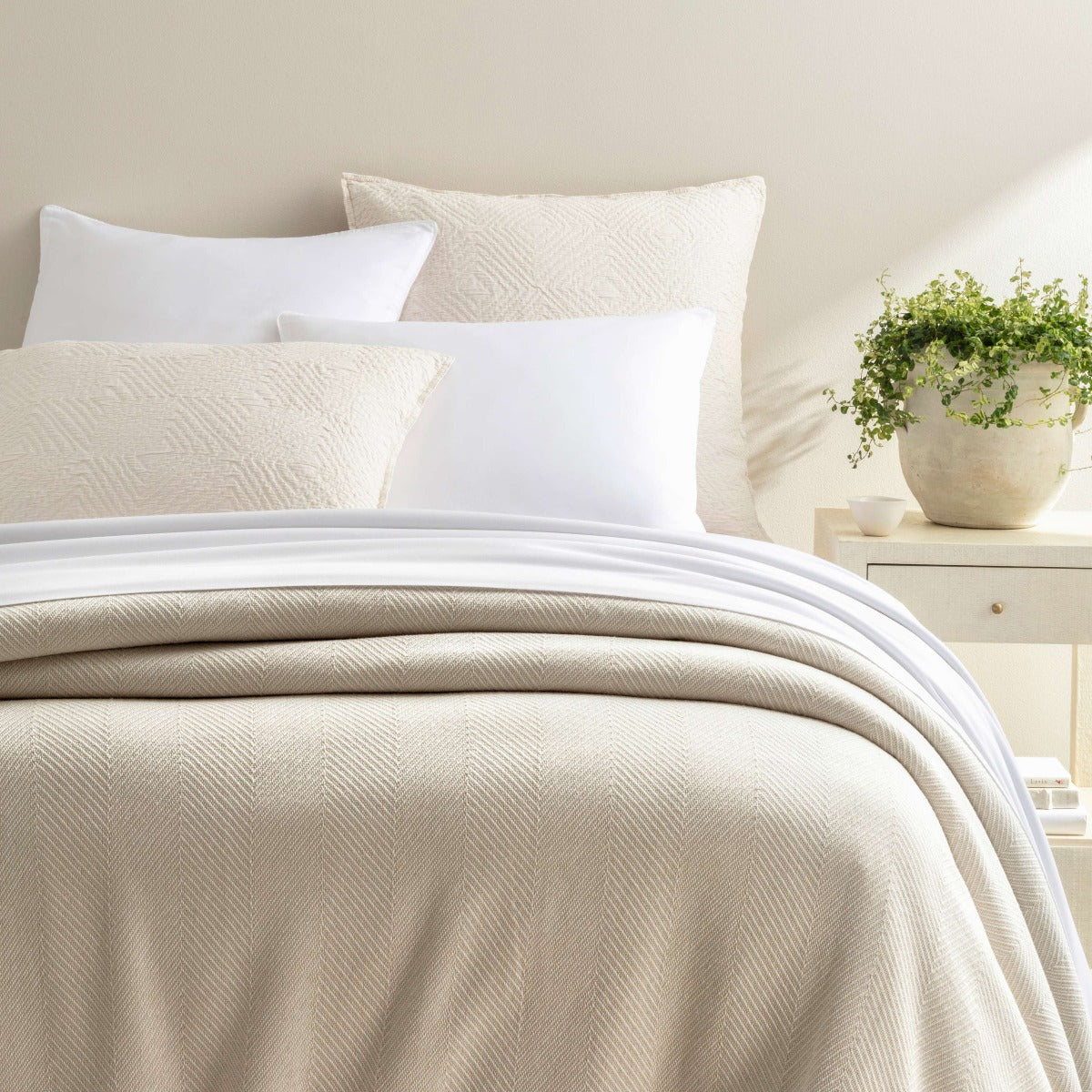 Herringbone White/Ivory Blanket styled with neutral bedding. Styled view. 