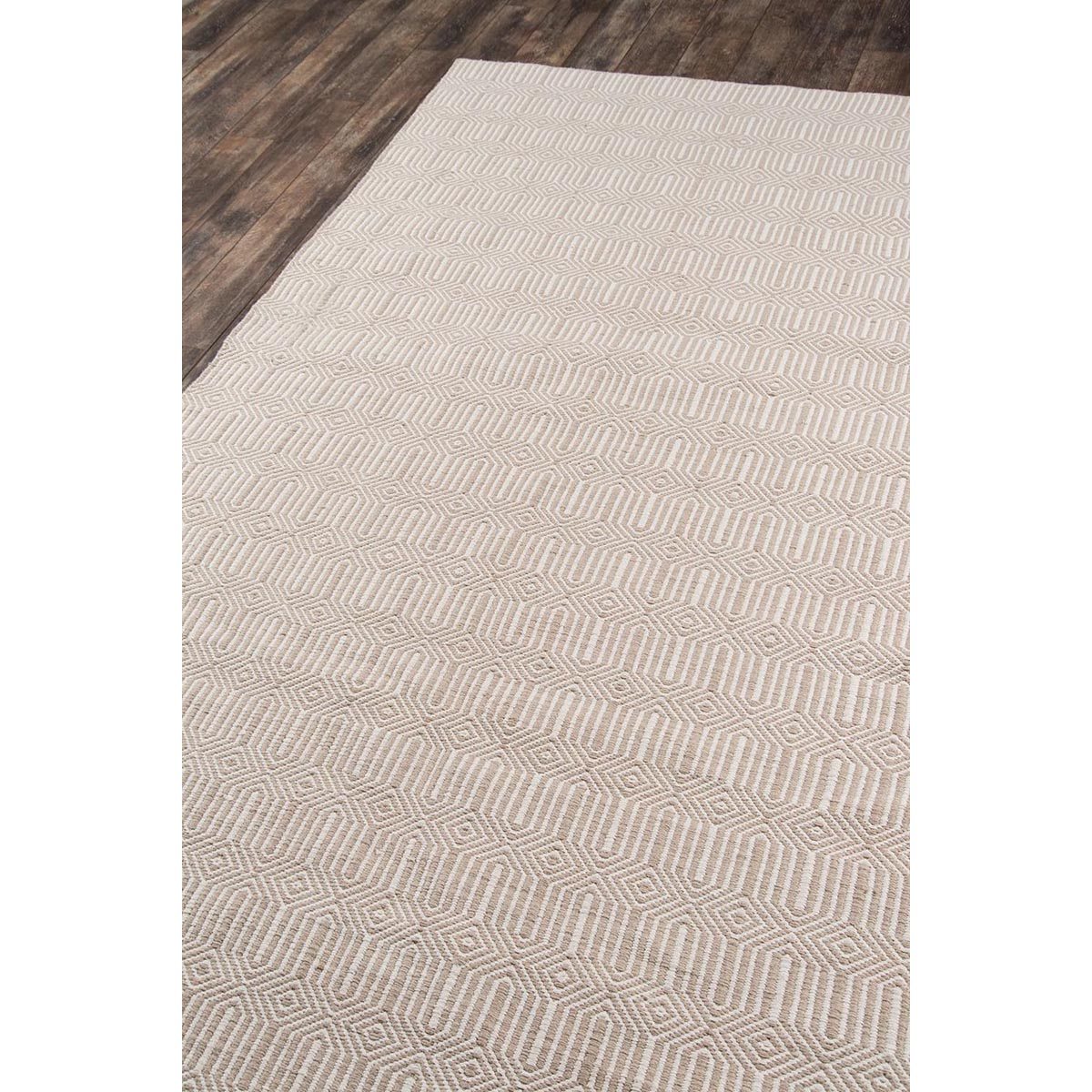 Huron Indoor/Outdoor Rug - Beige over wood floor. Styled view.