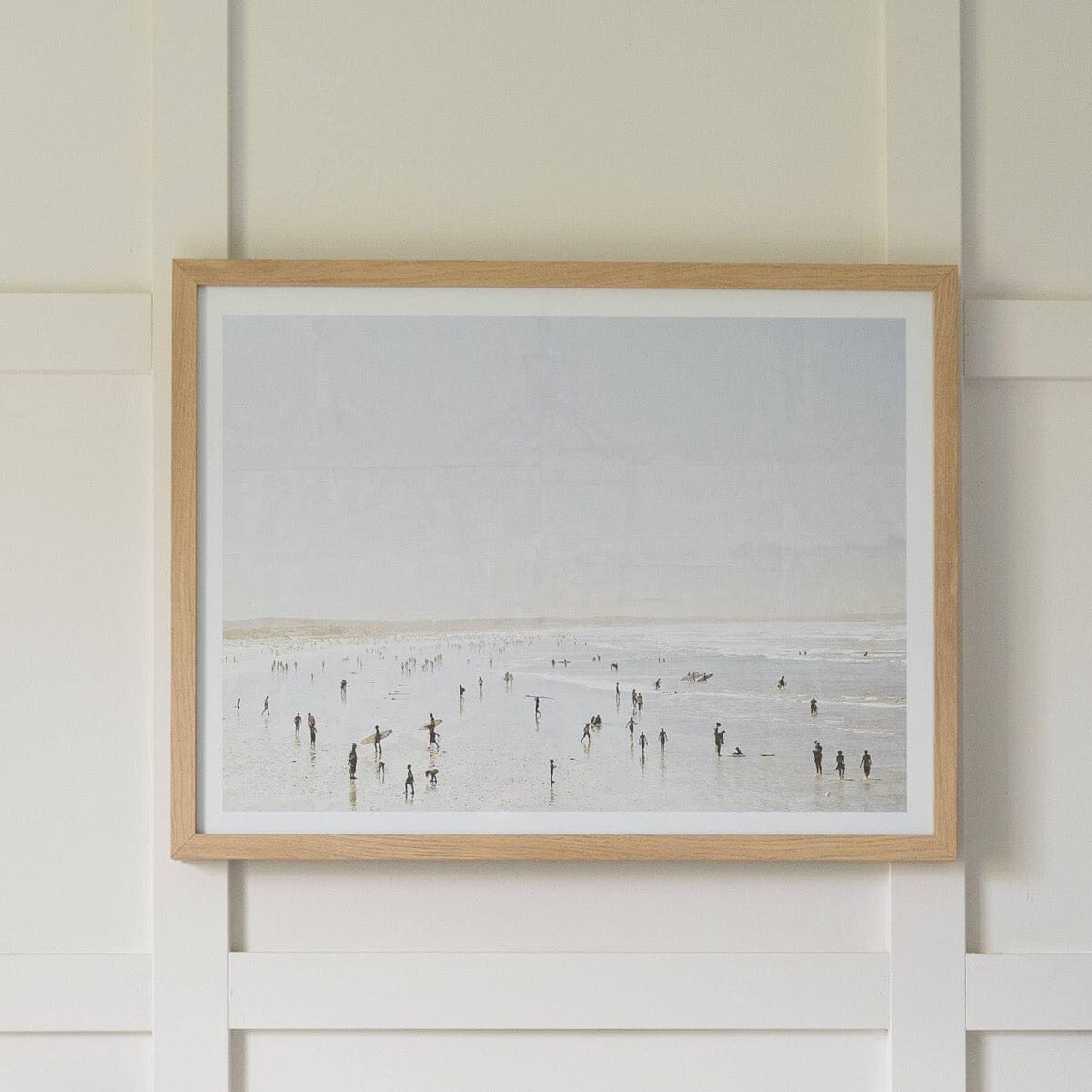 Idyllic Surf hung on a white panel wall. Styled view.