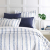 Ink Dots Duvet Cover styled with navy sheets. Styled view. 