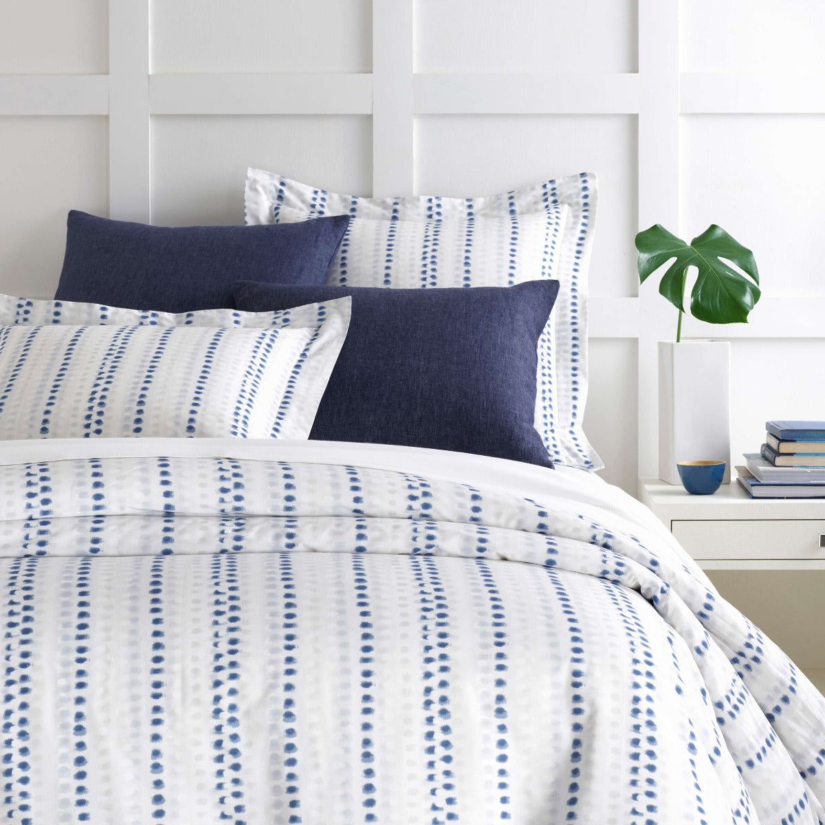 Ink Dots Duvet Cover styled with navy sheets. Styled view. 