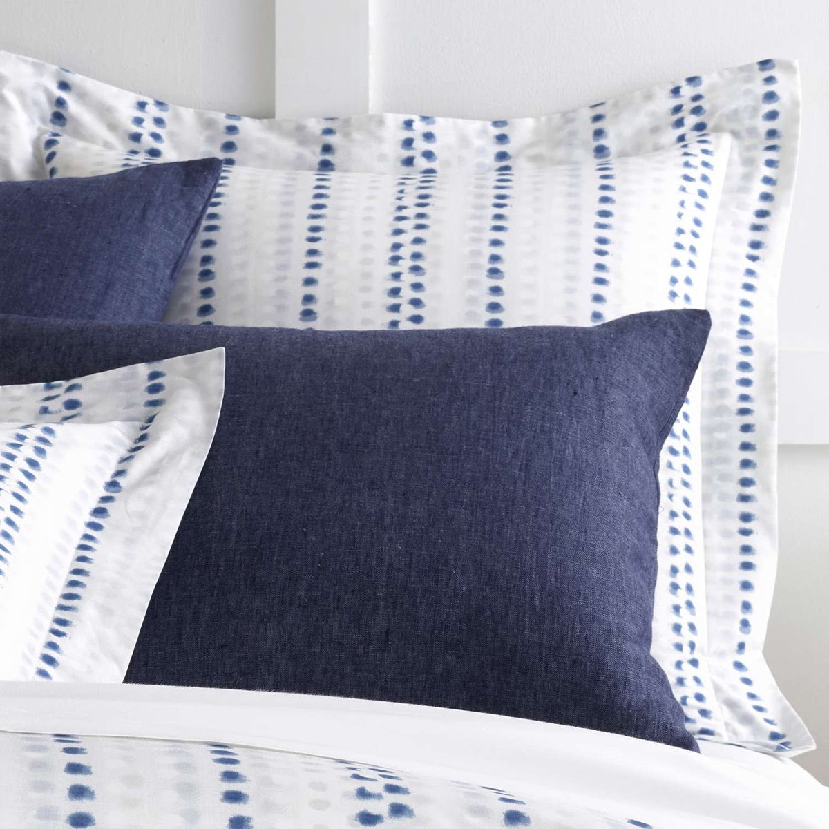Ink Dots Sham styled with navy sheets. Styled view. 
