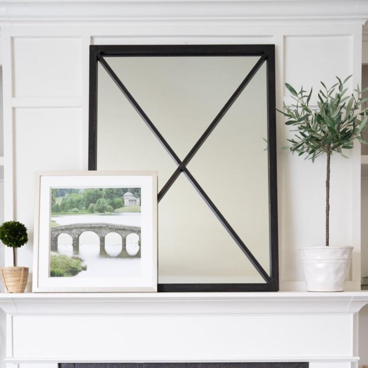Jardin Vert Formel VI styled in front of black mirror on a white mantel. Styled view.
