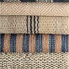 Jute Ticking Indigo Woven Rug styled with neutral rugs. Styled view. 