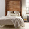 Jute Woven Bleached Oak Rug styled in a neutral bedroom. Styled view. 