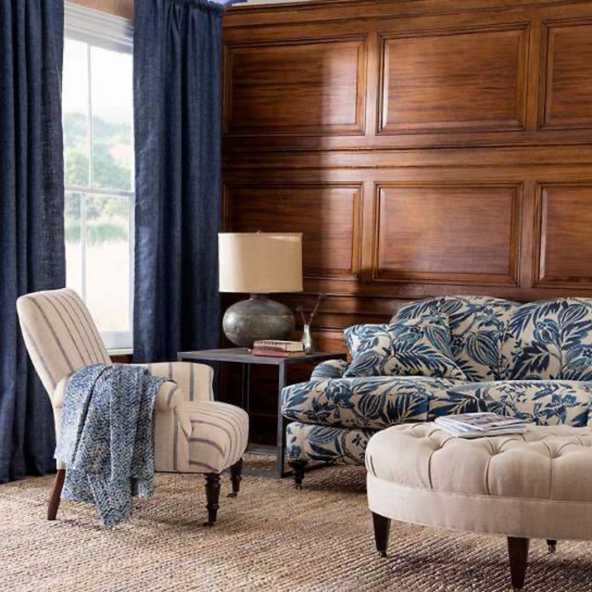 Jute Woven Natural Rug styled in a blue living room. Styled view. 