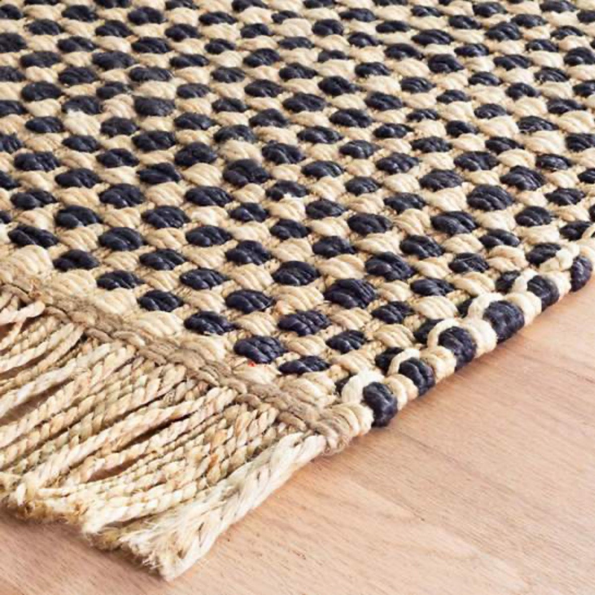 Kuba Black Woven Jute Rug corner detail. Close-up detail view. 