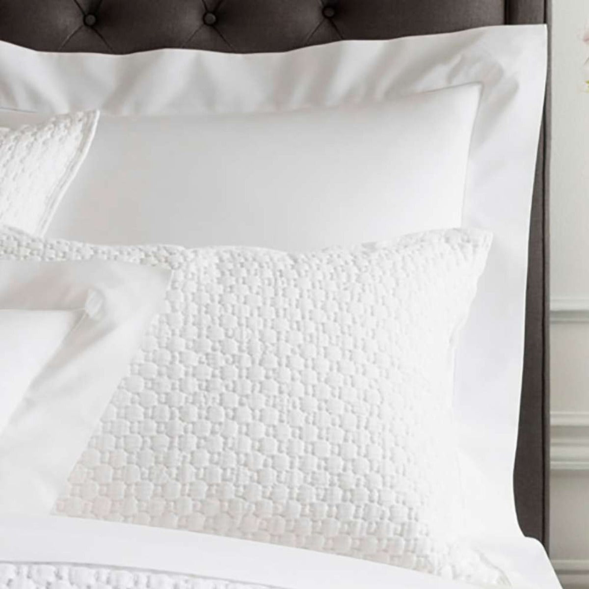 Lodi White Matelasse Sham styled with white sheets. Styled view. 