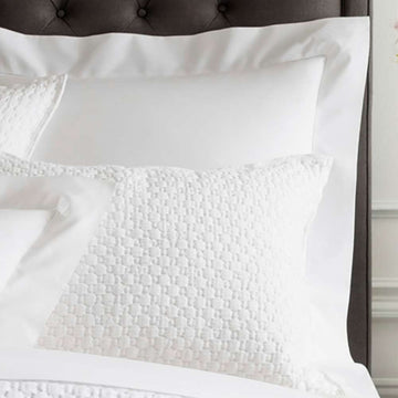 Lodi White Matelasse Sham styled with white sheets. Styled view. 