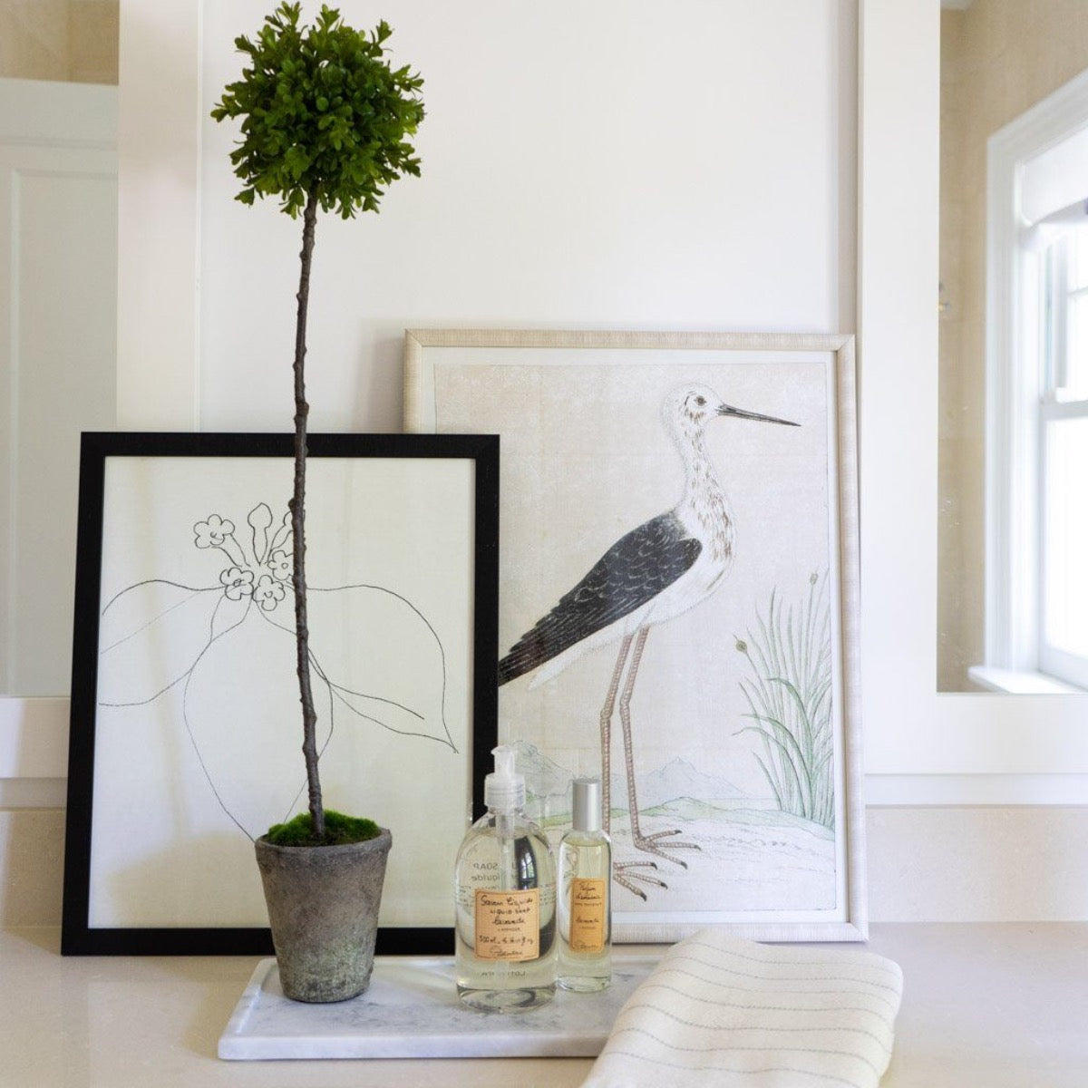 Long Marble Tray styled with greenery, soaps and artwork. Styled view. 